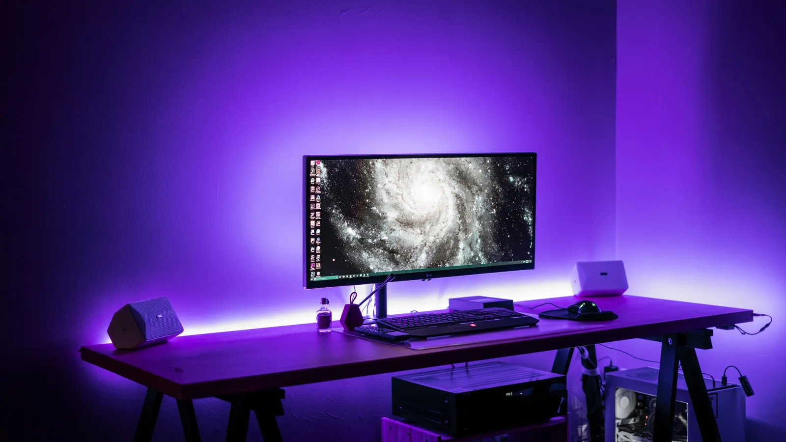 A desk video setup with a widescreen monitor